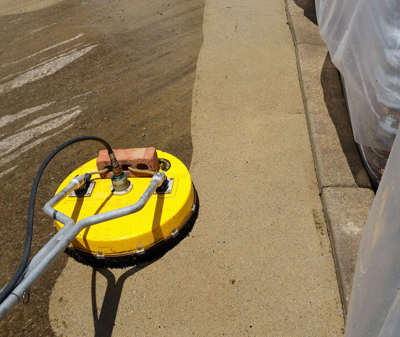A yellow surface cleaner is on the sidewalk.